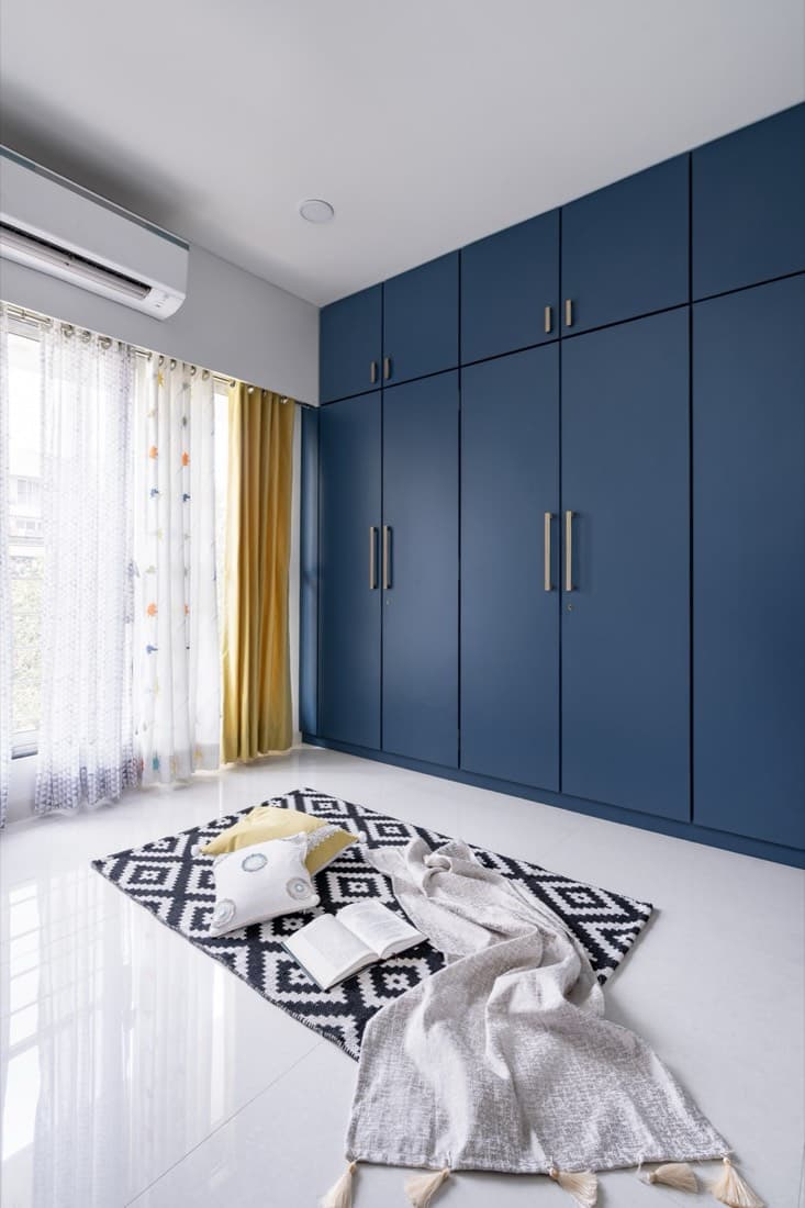 Navy hinged wardrobe with brass handles